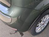 a close up of a car ' s rear end with the door open