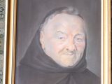 portrait of a man with a black robe and a black hat