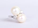 pearl and diamond ring on a white background