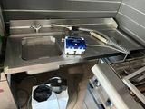 a sink with a phone on it in a kitchen