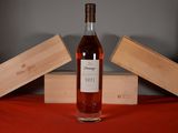 a bottle of wine sitting on a table next to a box