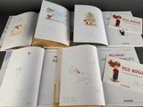 several children ' s books with drawings and pictures of animals on them