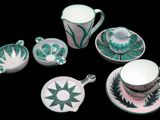 four cups and a saucer and a teacup on a table