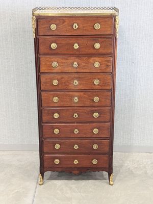 an antique wooden chest of drawers with brass hardware on top