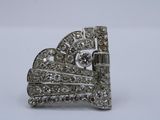 a close up of a diamond broochle on a white surface