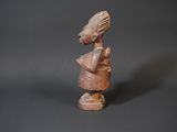 figurine of a woman with a hat on her head