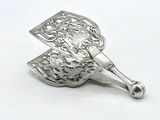 a silver spoon that is sitting on a white surface