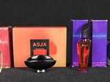 many different types of perfumes and boxes on the table