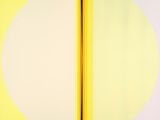 yellow and white circles on a yellow wall with a black pole
