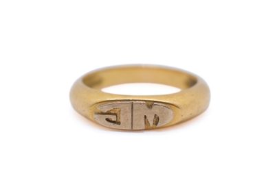 a close up of a gold ring with a small initials on it