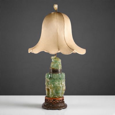 a lamp with a green lamp shade on top of it