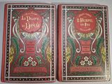 two red books sitting on top of a table next to each other