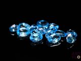a close up of a bunch of blue crystals on a black surface