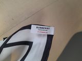 the label is attached to the back of a white and black shirt