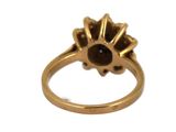 an image of a gold ring with a black stone in the center