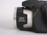 a close up of a digital camera on a white surface