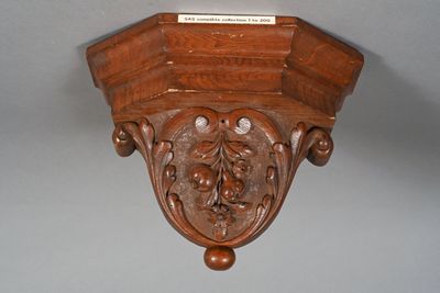 a wooden shelf that has a plaque on it