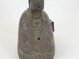 an old metal bell on a white surface with a white background