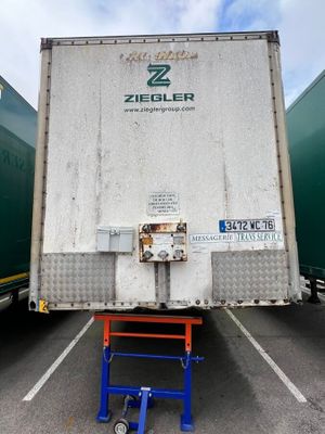 two trucks that are parked in a parking lot