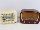 two old fashioned radio ' s sitting side by side on a white surface
