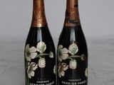 two bottles of wine sitting on a marble table