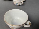 three cups that are sitting on a table next to each other