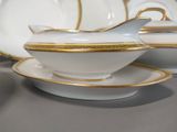 a white and gold gravy with gold trim on it