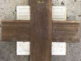 wooden cross on concrete floor with white and brown paint