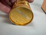 a person holding a gold cup that is sitting on a table