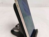a cell phone that is sitting on top of a stand