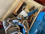 a box full of tools sitting on the floor next to a wall