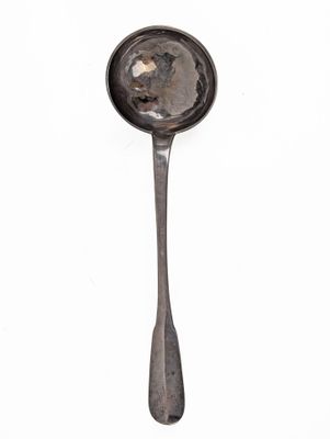 a spoon with a spoon handle on it on a white surface