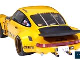 a yellow car that is sitting on a white surface