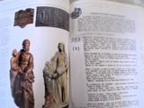 an open book with a picture of a statue on it