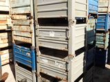 a man standing in front of a stack of crates