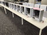 rows of computer desks in a large open office space