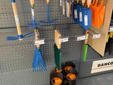 many different types of garden tools displayed on the wall