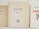 three books are lined up on a table with a white background