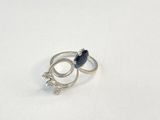 a silver ring with a blue stone on it