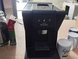 une cafetière posée sur une table à côté d'une tasse