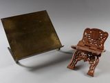 a miniature chair and a mirror on a white surface