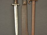 two knives are sitting next to each other on a table