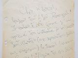 an old piece of paper with writing on it sitting on top of a table