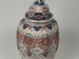 a vase with a lid that has an elephant on it