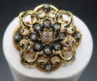 a close up of a gold and diamond ring on a white pedestal