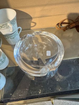 a glass table with cups and glasses on it