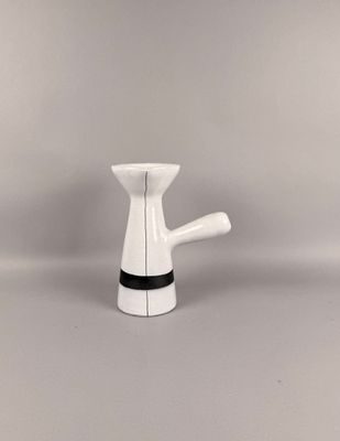 un petit vase blanc orné d'une bande noire