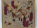 embroidered picture of a horse and her foal in a field of flowers