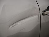 a close up of a car door handle with a dent in it