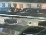a close up of a car ' s dashboard with a clock on it